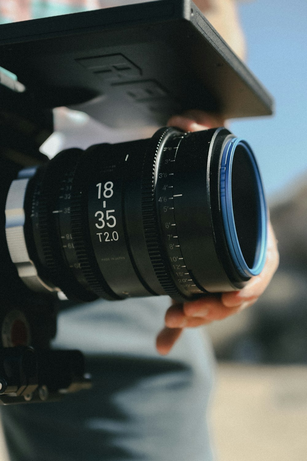 black camera lens on persons hand