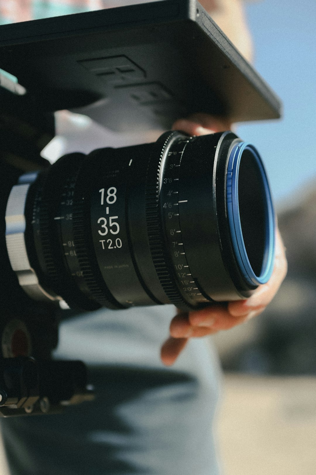 black camera lens on persons hand