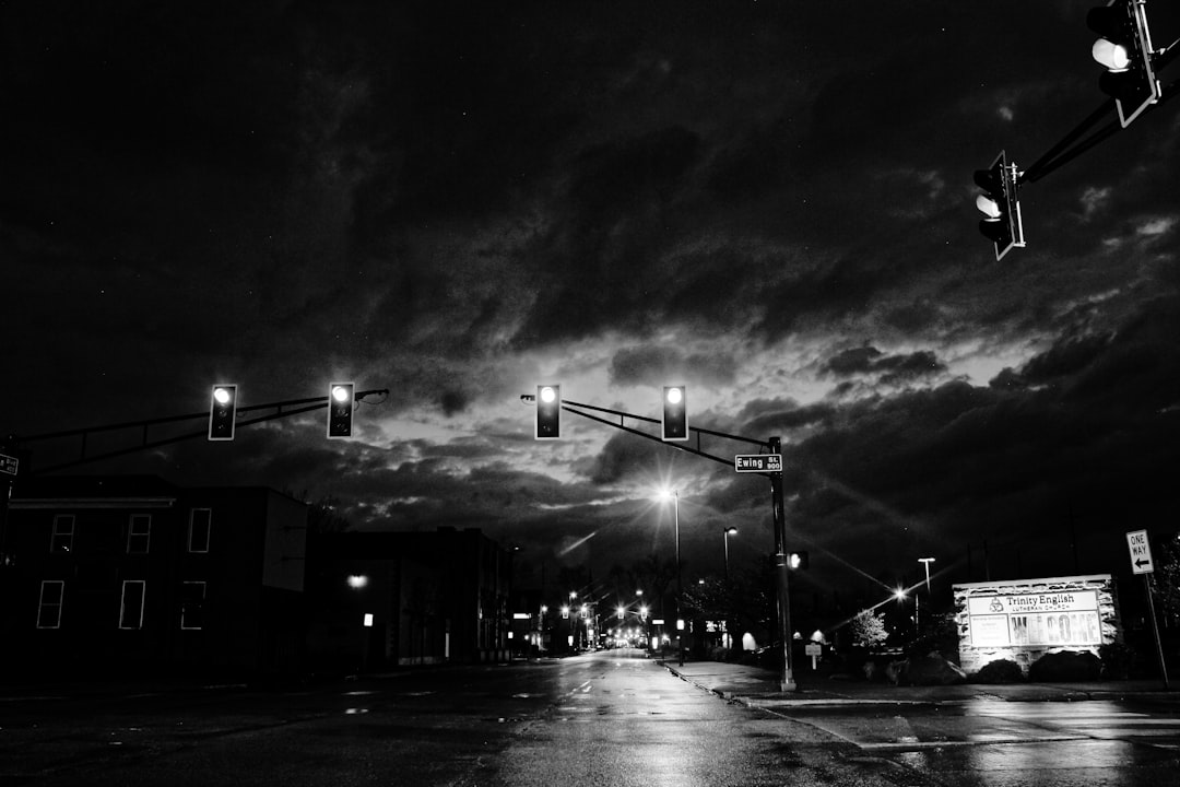 grayscale photo of street lights during night time