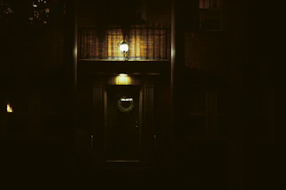 Cozy apartment entrance with a welcoming door and warm lighting at dusk.