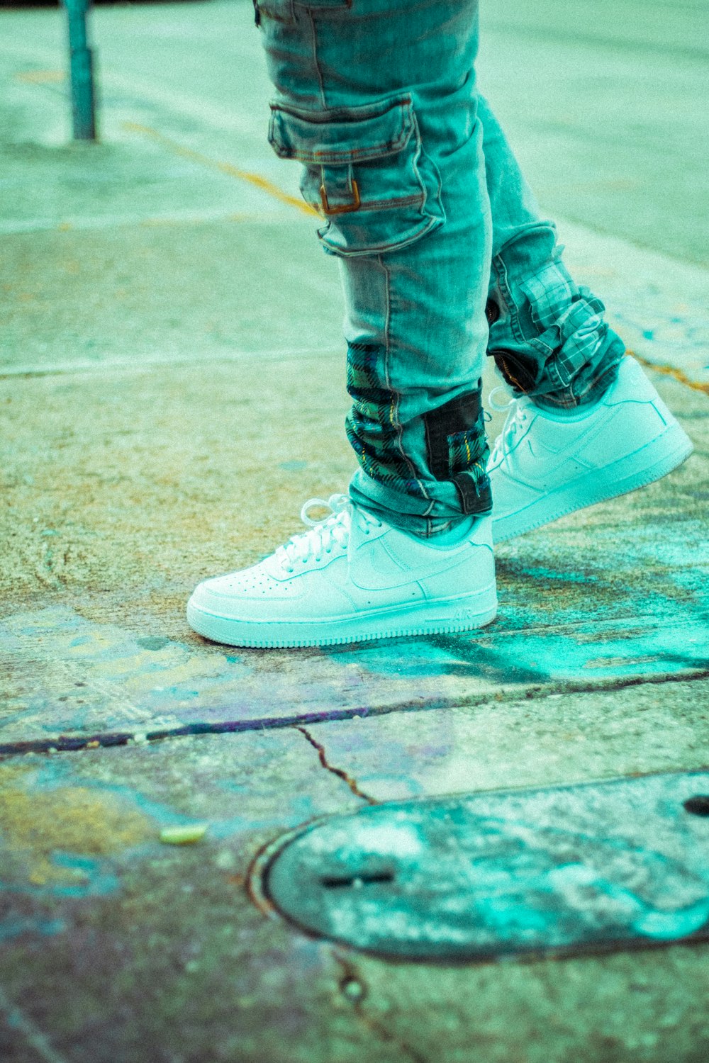 person in blue denim jeans and white nike sneakers