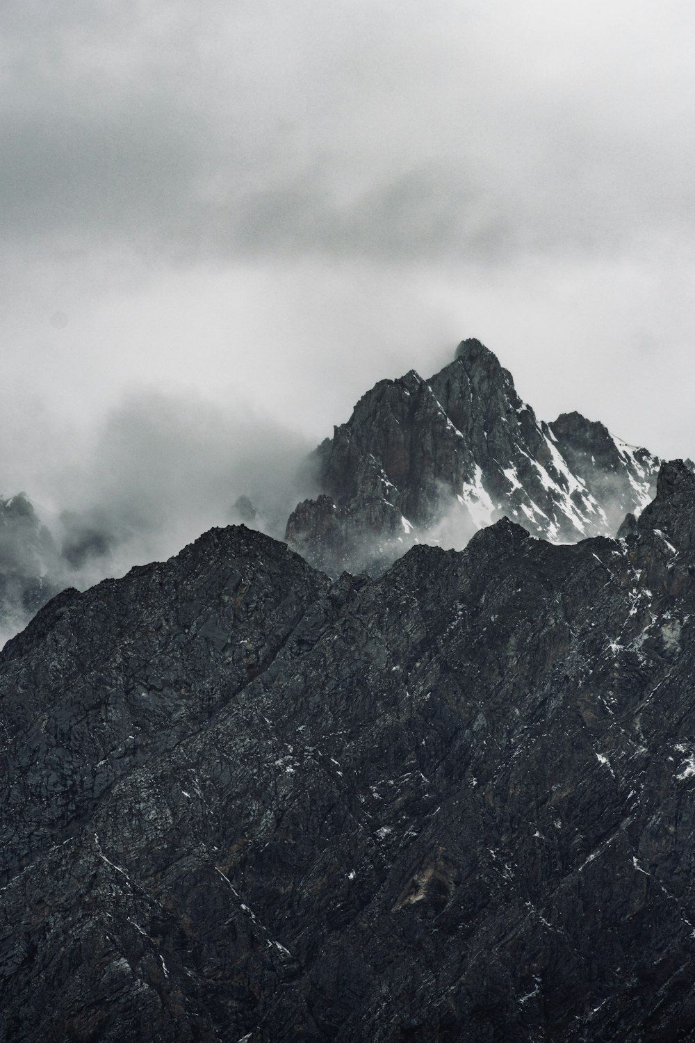 gray and white mountain under white clouds