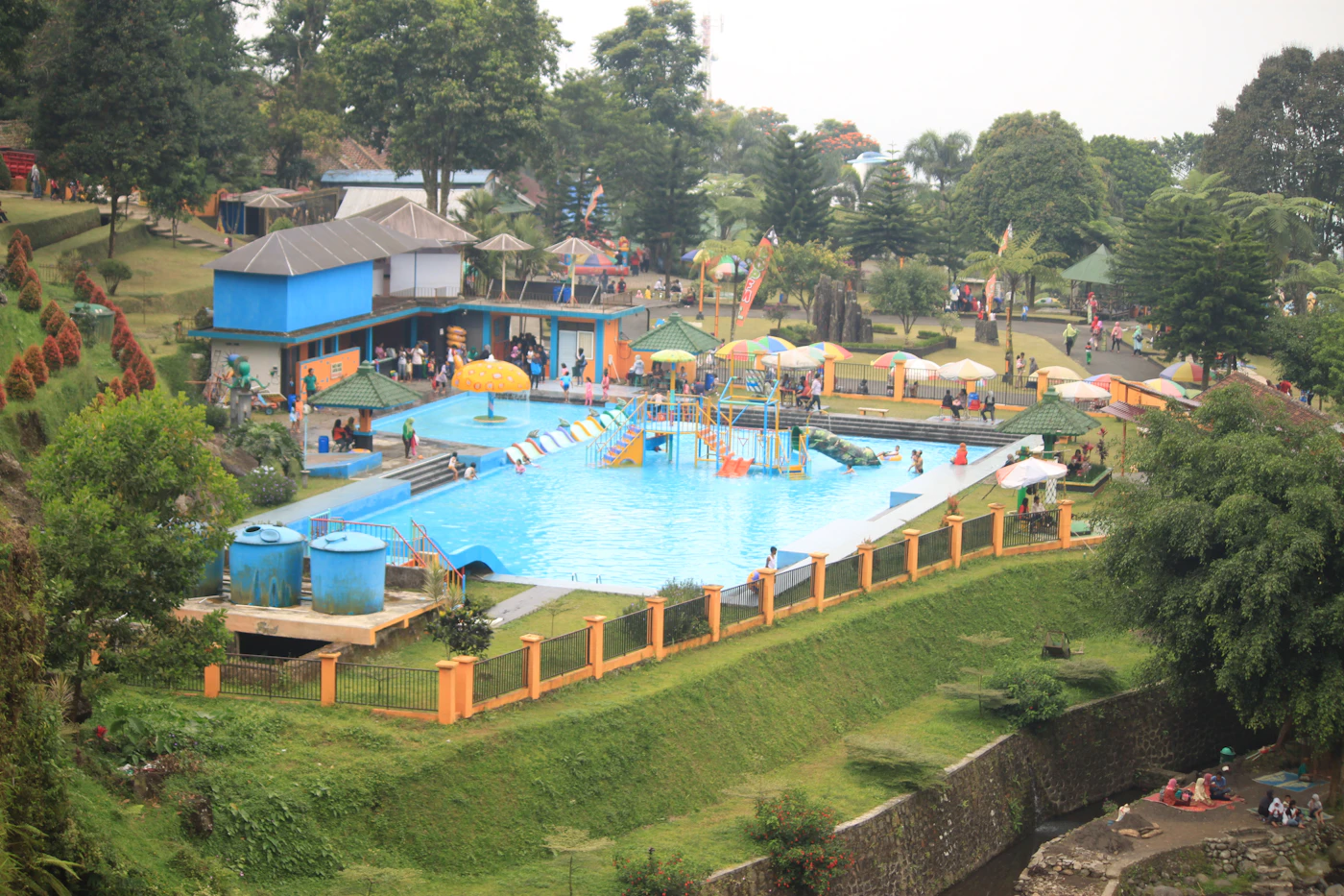 Indonesian-style wooden houses and water body at Sumatra outdoor wedding venue JP Nagar Bangalore