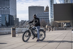 A modern electric bike charging beside a wooden bench in a city plaza