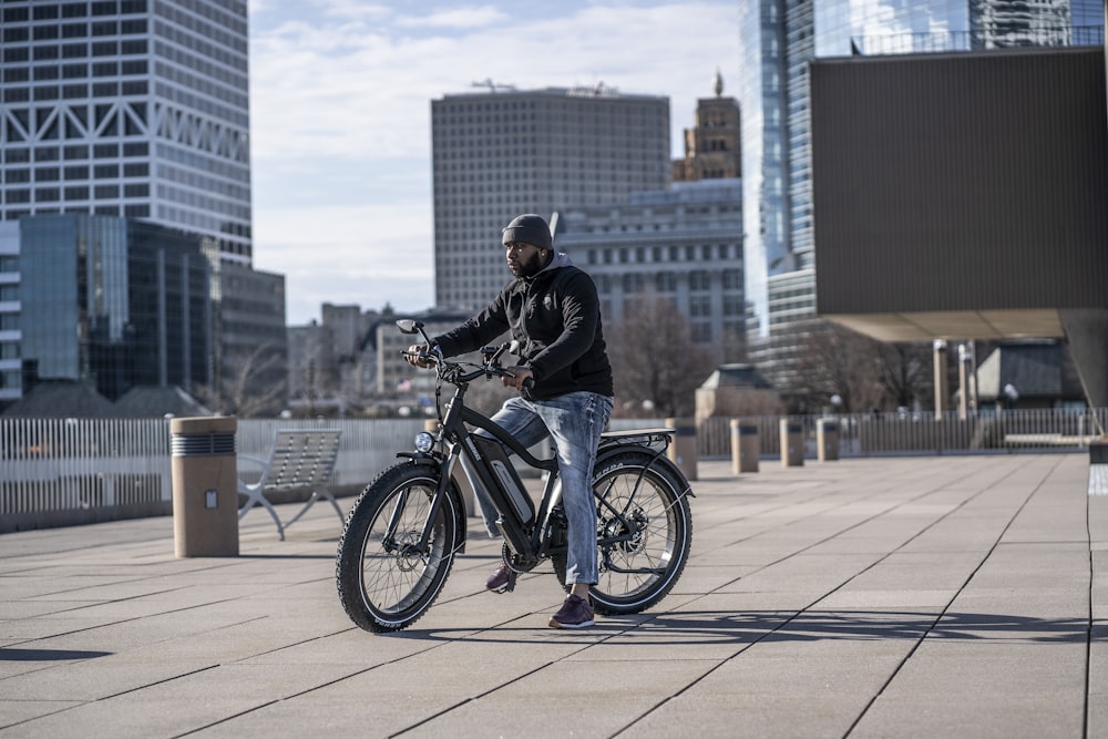 man in black jacket riding on black motorcycle during daytime