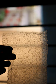 Transparent stretch film securing goods on a pallet, highlighting its elasticity and strong grip.