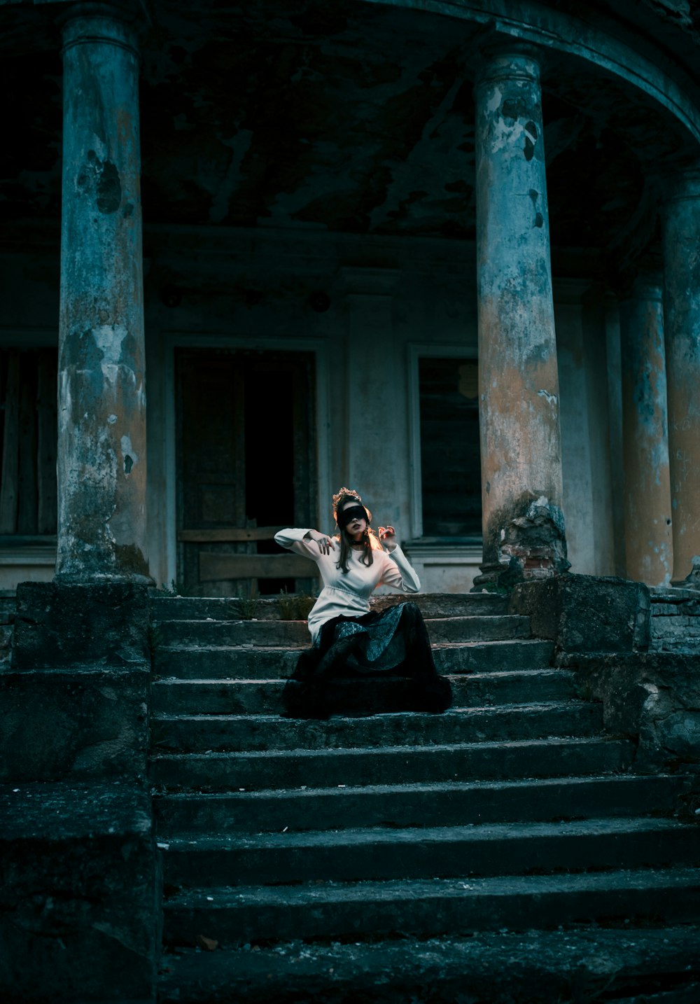 woman in black dress sitting on stairs