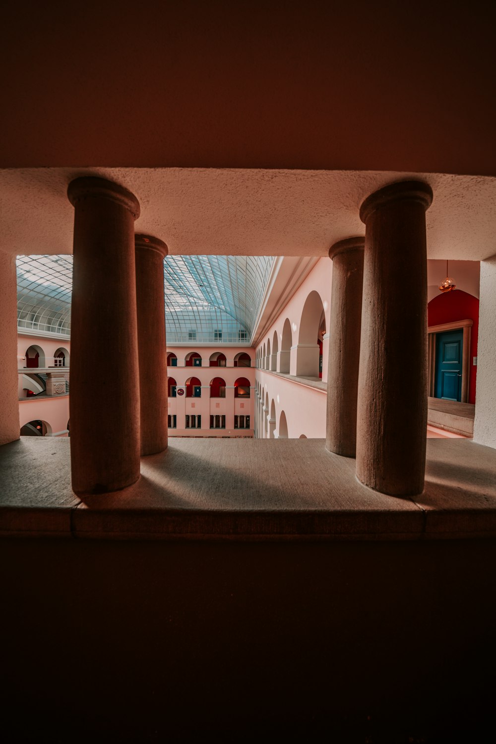 brown wooden pillar on white concrete building