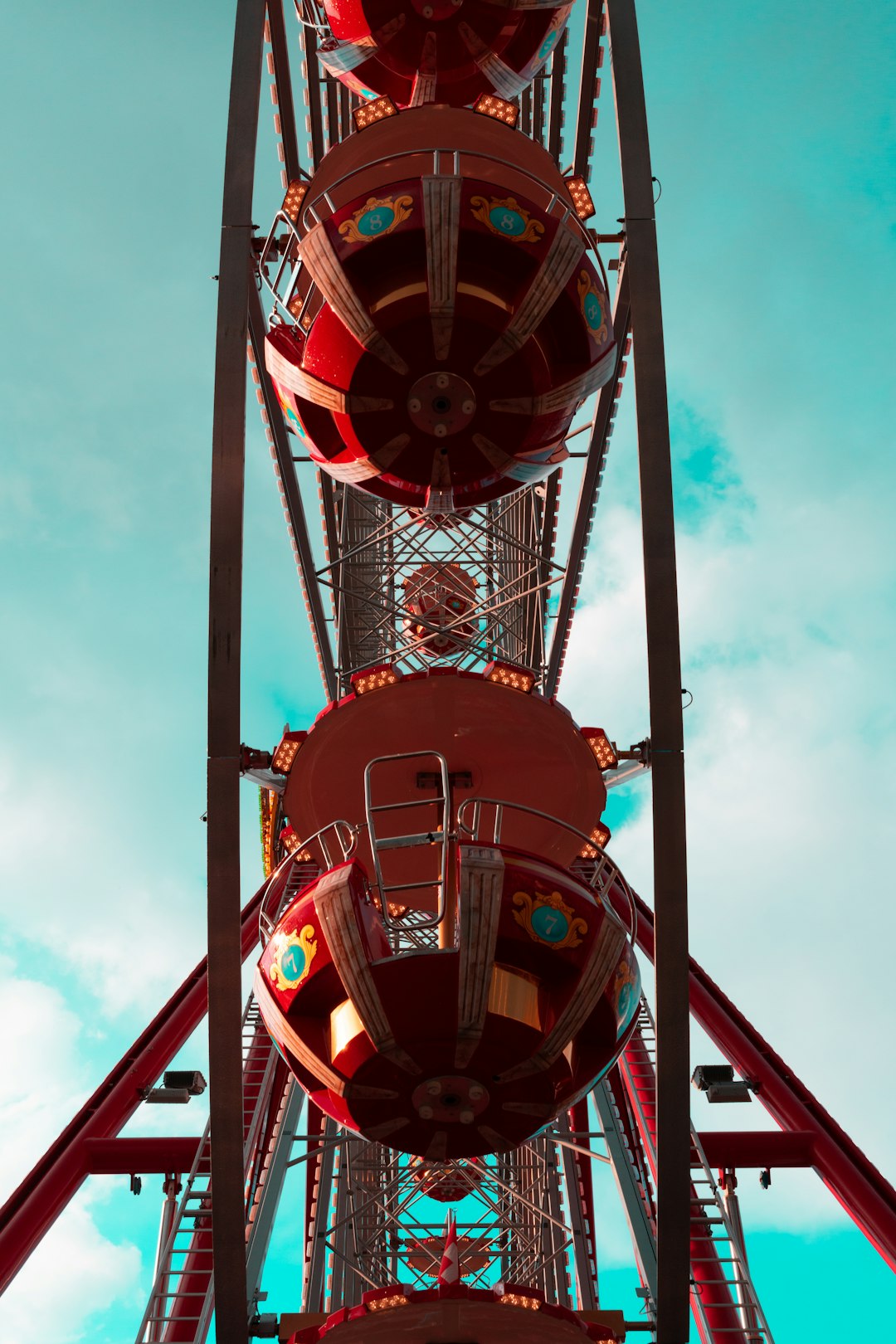 red and black ferris wheel under cloudy sky during daytime