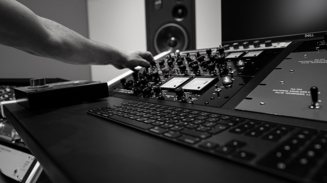 person holding black audio mixer, Top-notch music studio gear photography background