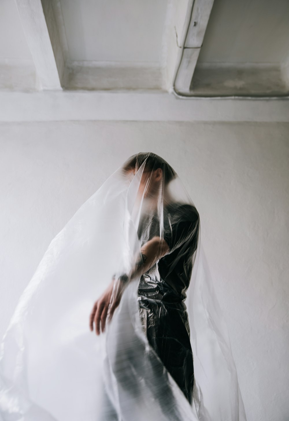 woman in white veil covering her face