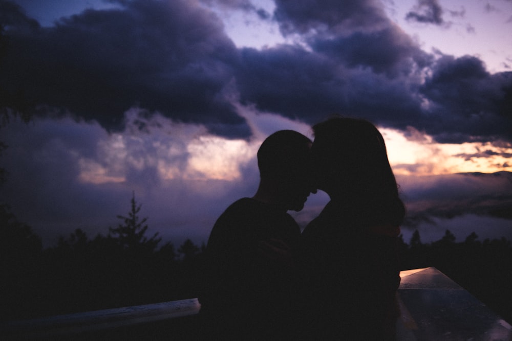 silhouette of man and woman kissing