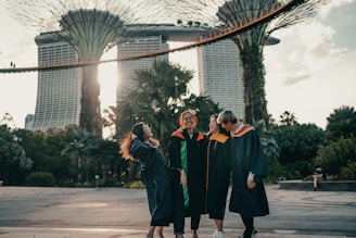 woman in black academic dress standing on gray concrete floor during daytime