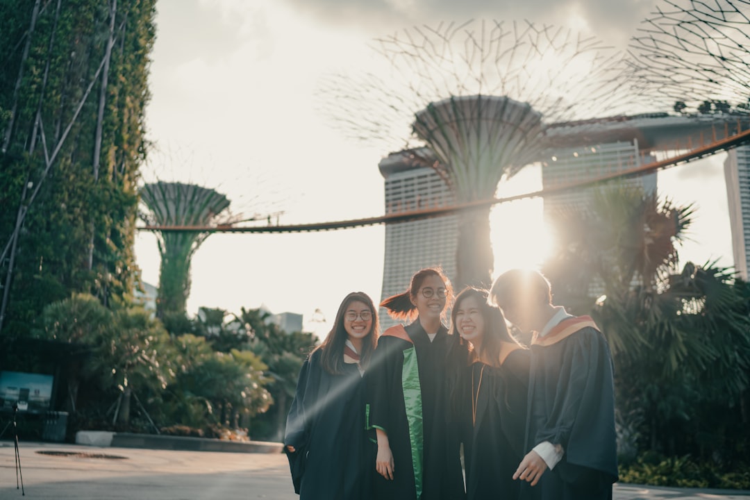 group of people in black robe standing on gray concrete floor during daytime