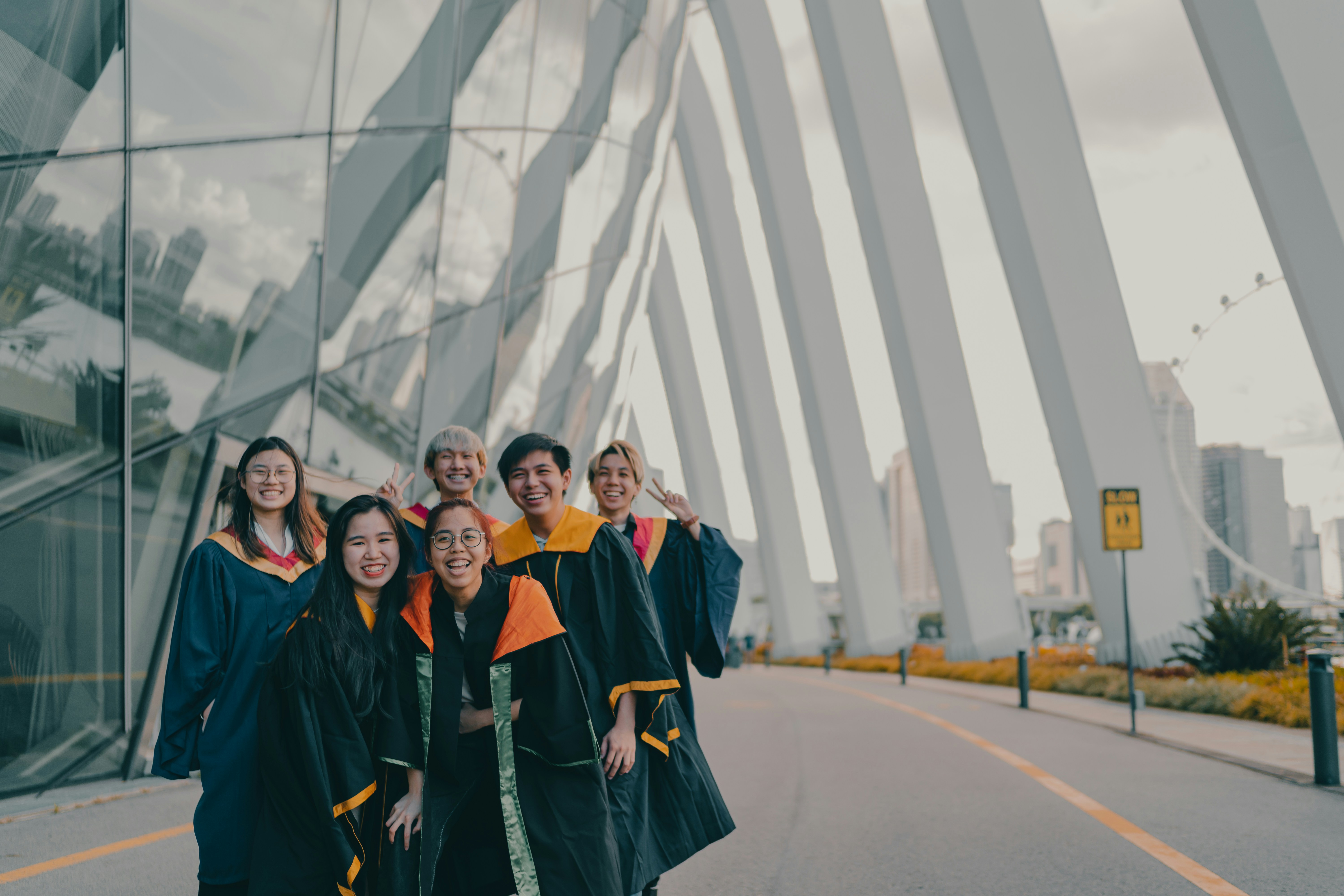 group of people in black uniform standing on gray asphalt road during daytime