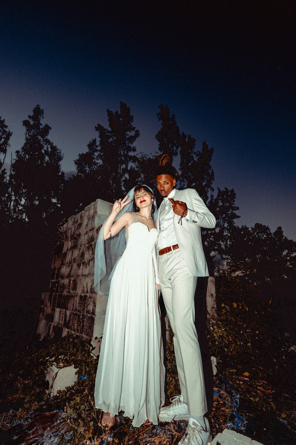 man in white thobe standing beside woman in white dress