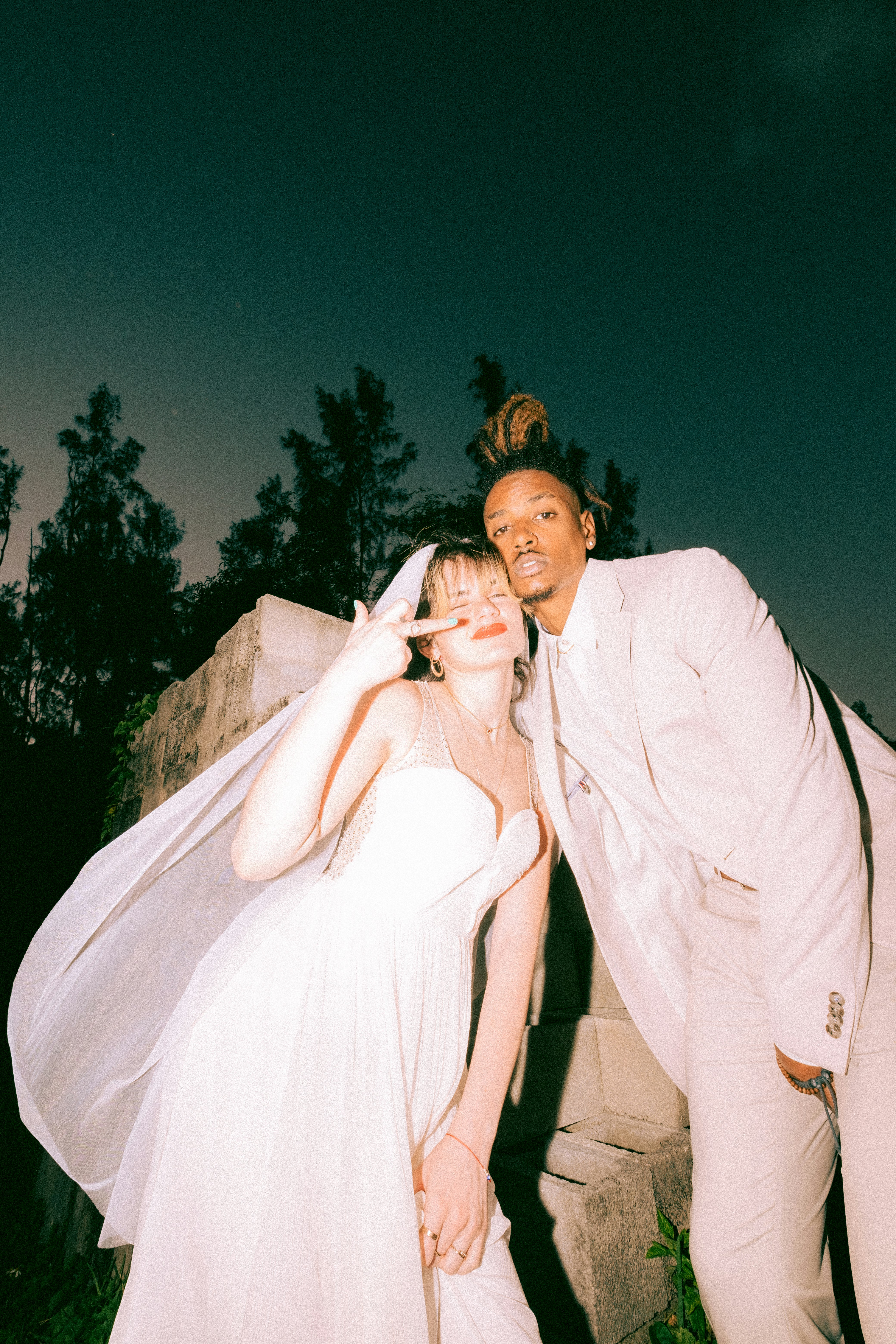 woman in white wedding dress beside man in gray suit