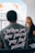 man in gray crew neck t-shirt sitting beside woman in black shirt