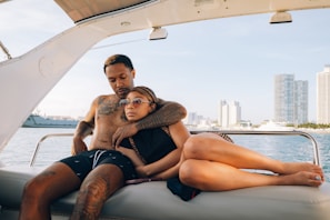 A happy couple enjoying a romantic boat ride on the Thames River at sunset.