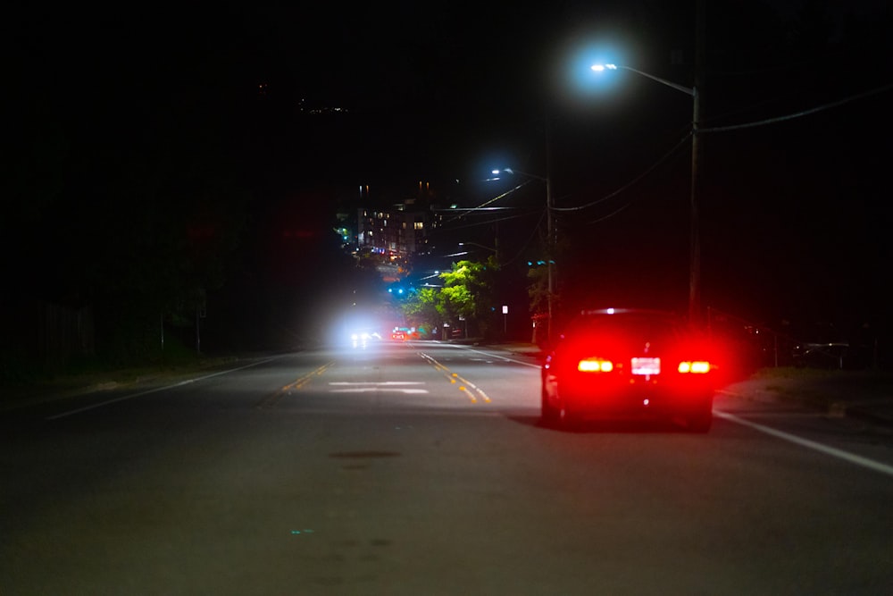 red car on road during night time