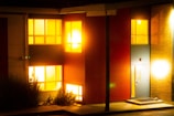 A welcoming exterior of a modern affordable home with warm lighting.