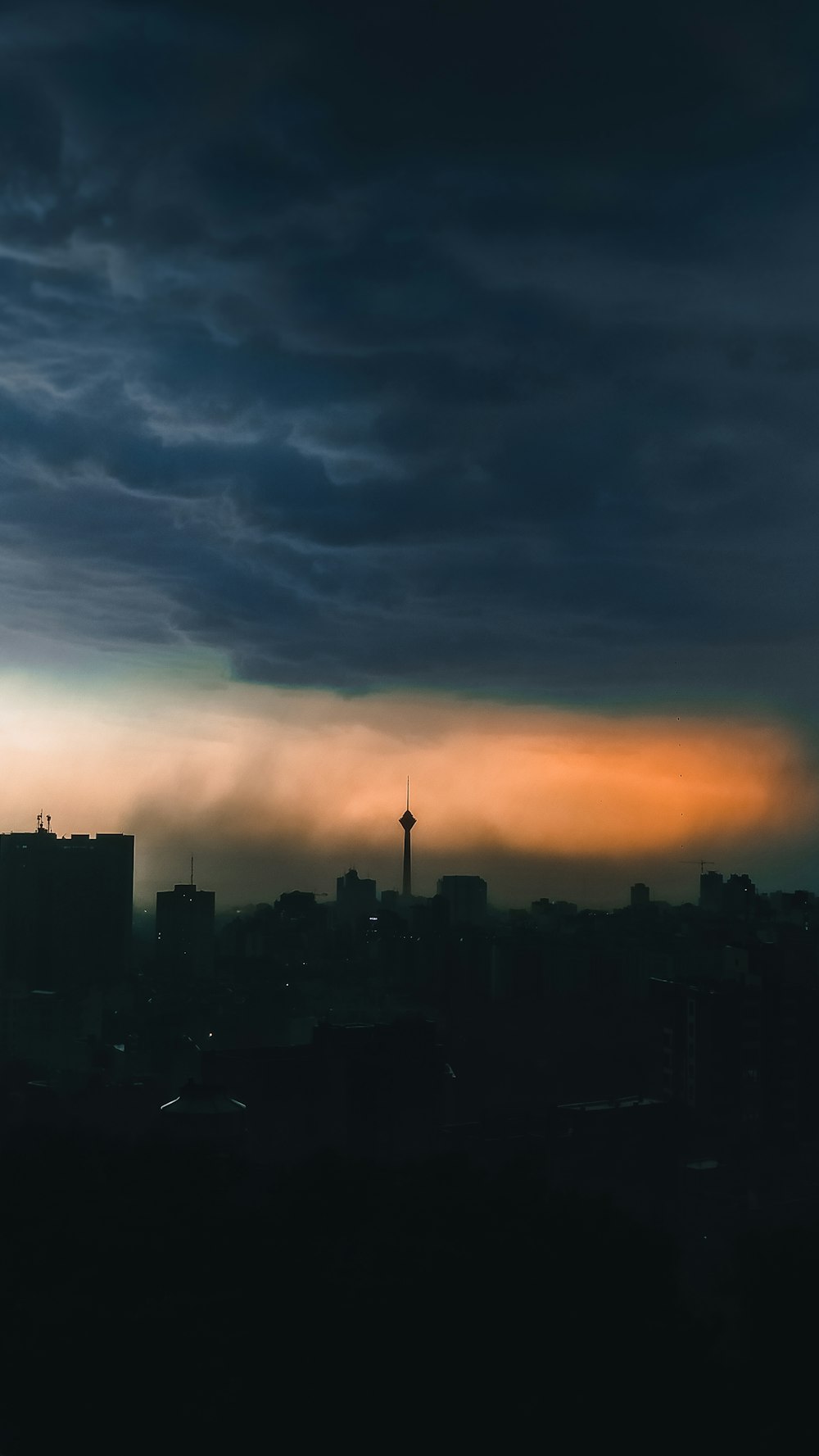 silhouette of city buildings during sunset