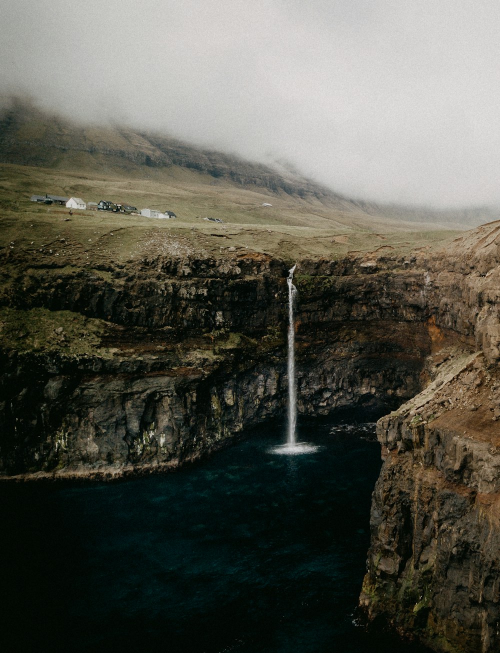 brown rocky mountain with water falls