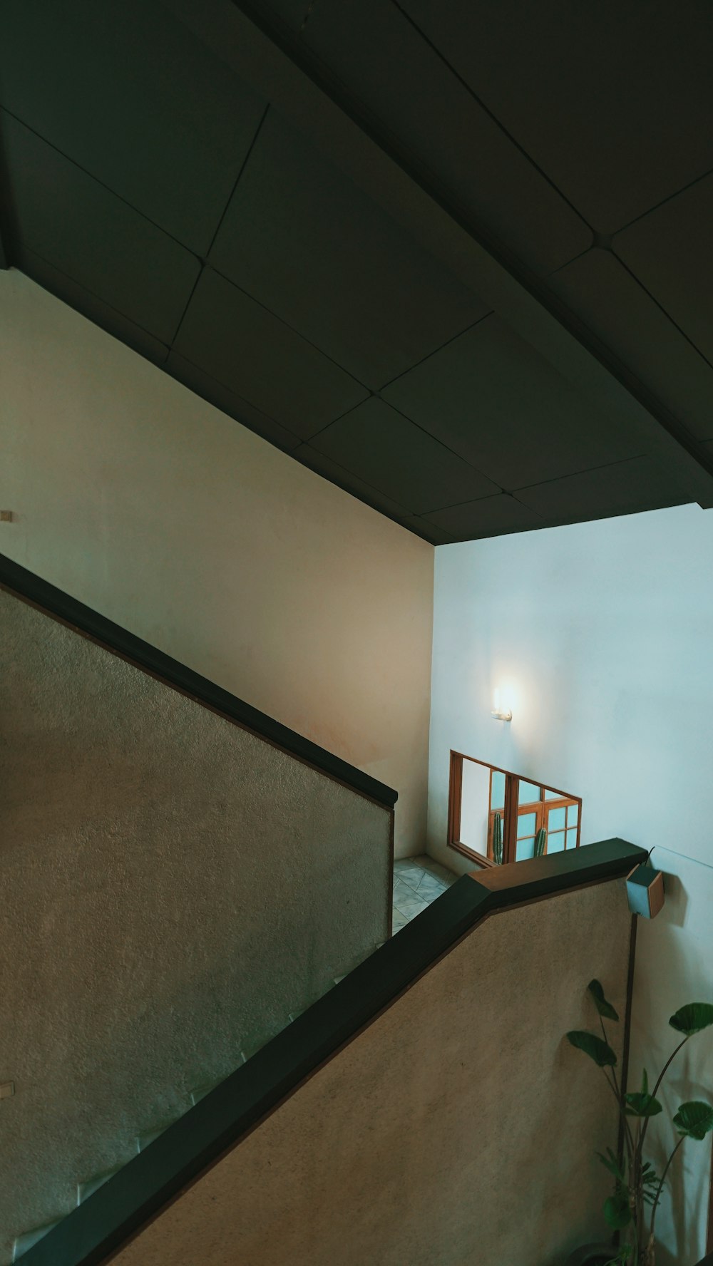 white wall paint near brown wooden staircase