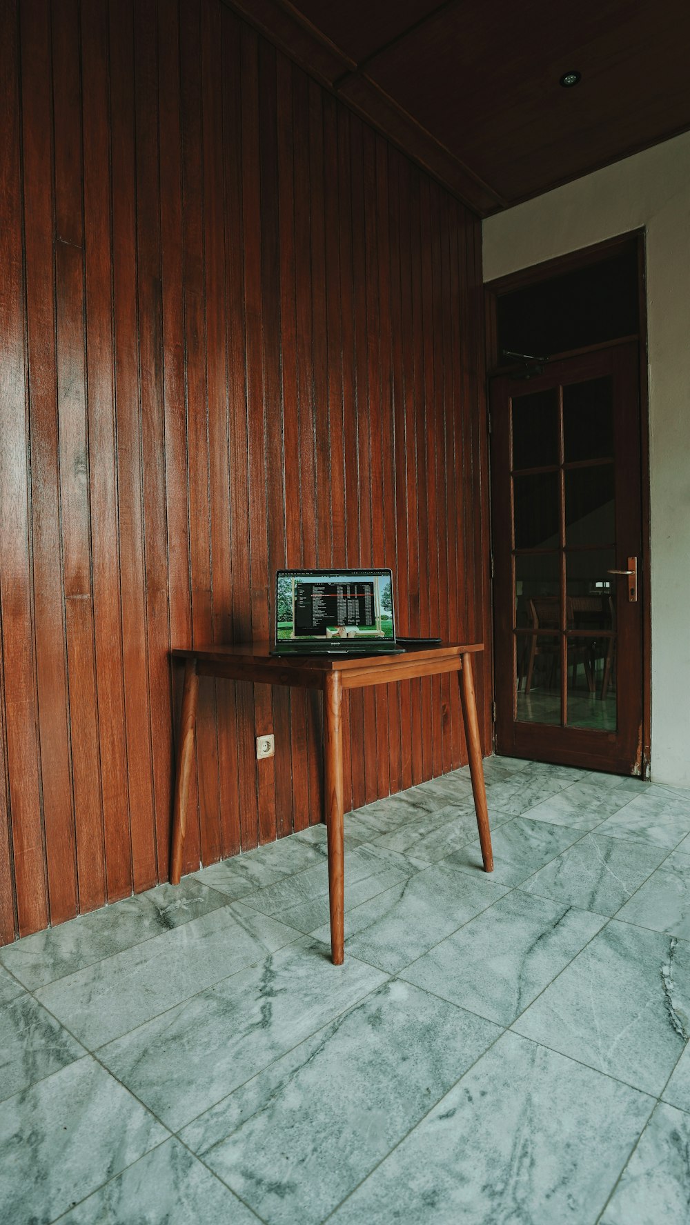 black and silver laptop computer on brown wooden table