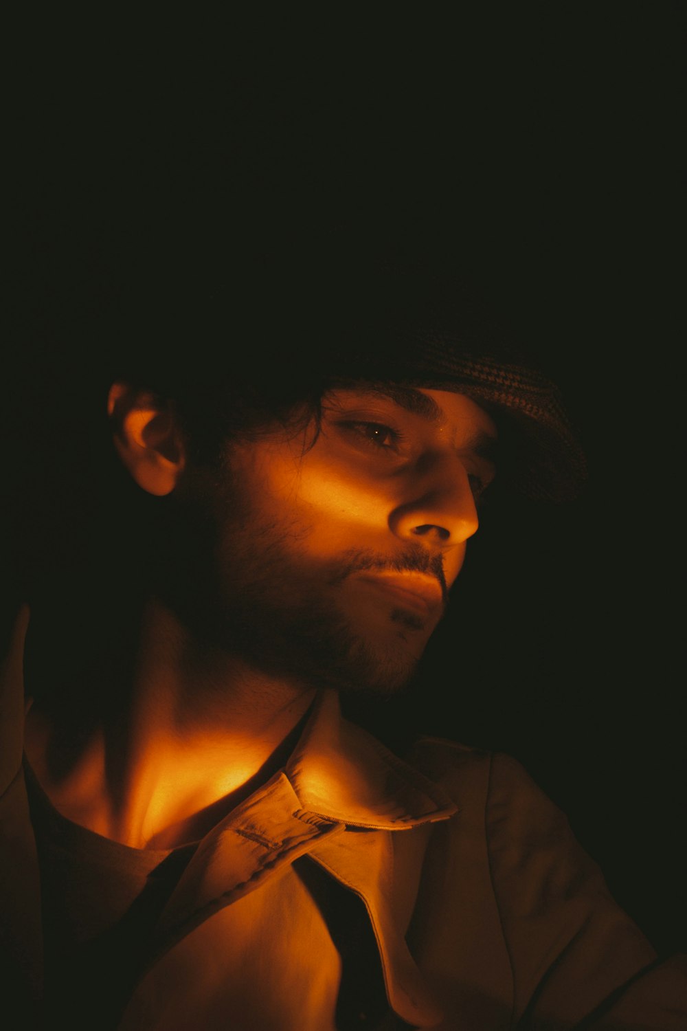 man in black hat and brown shirt