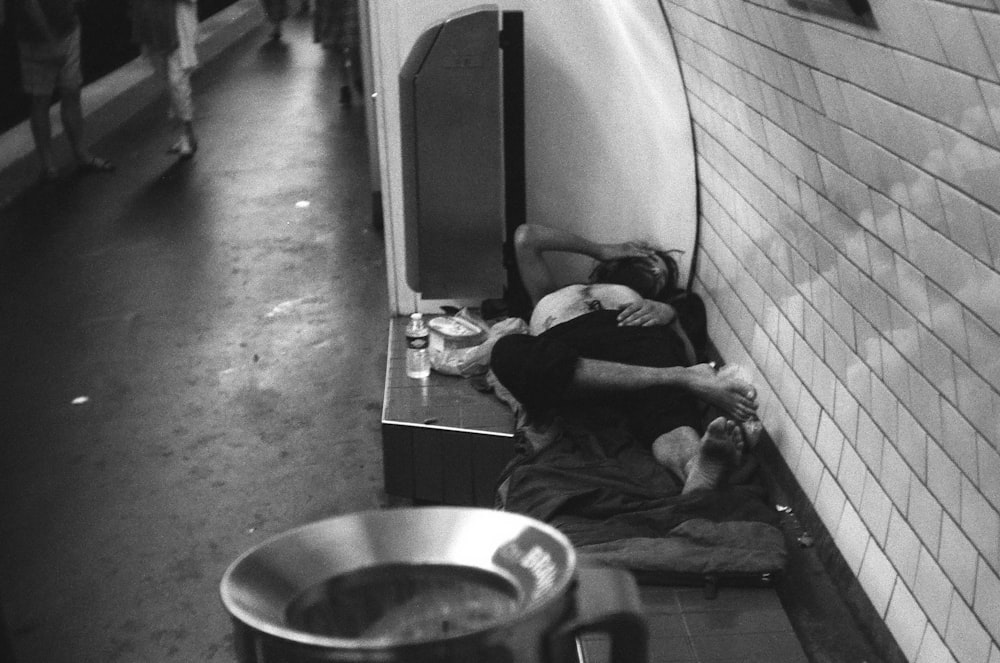 man in black jacket lying on floor