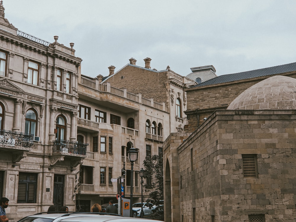 cars parked beside brown concrete building during daytime