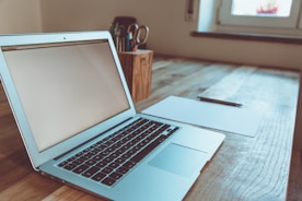macbook air on brown wooden table