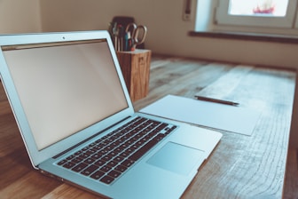 macbook air on brown wooden table
