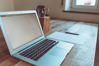 macbook air on brown wooden table