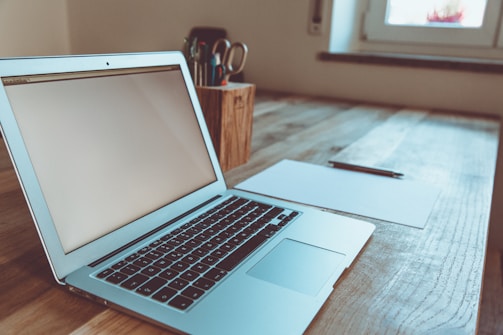 macbook air on brown wooden table