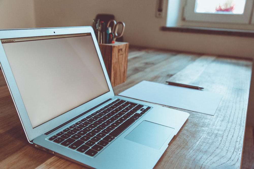 macbook air on brown wooden table