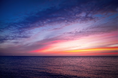 body of water under blue sky during sunset dreamlike google meet background