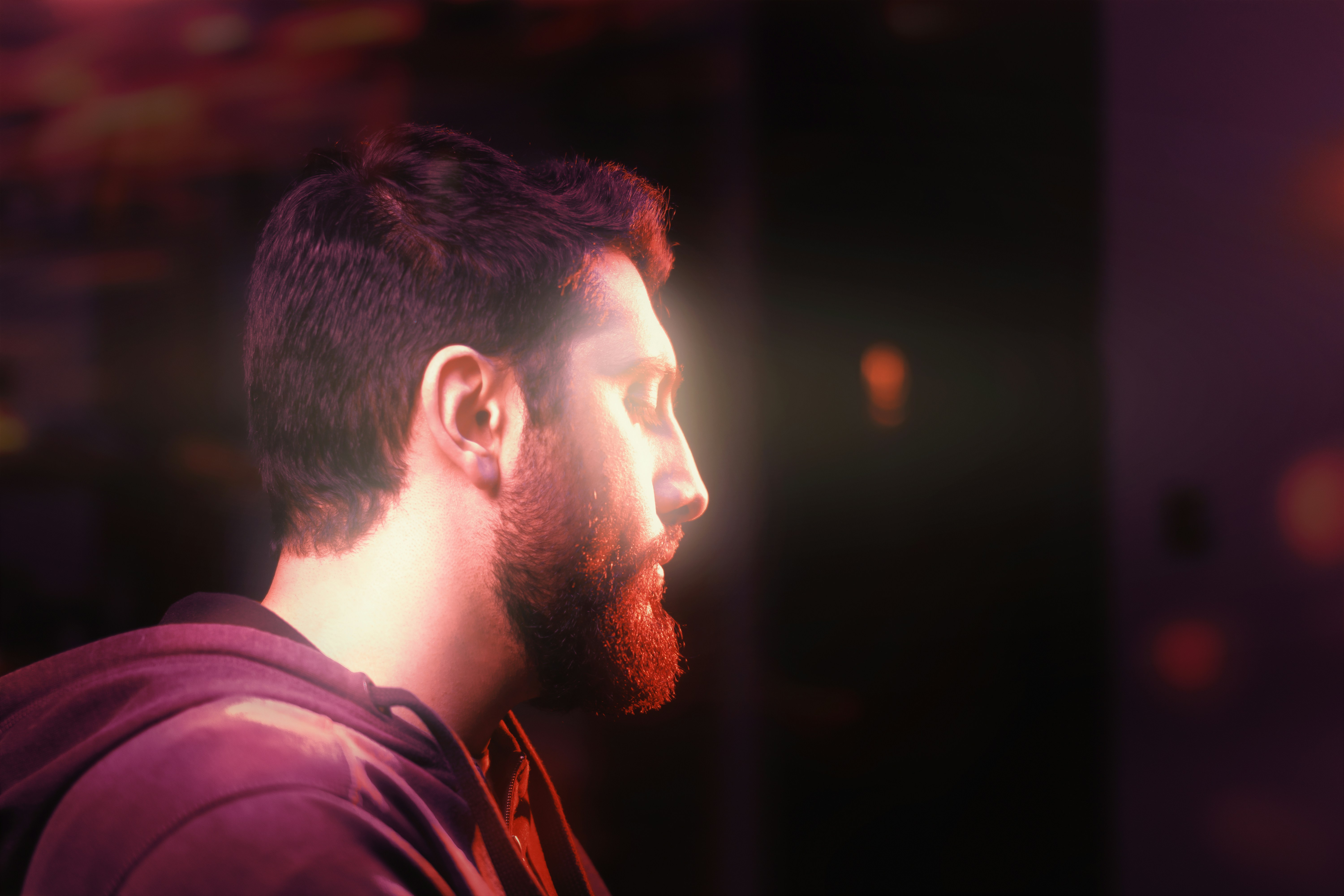 man in purple shirt looking down