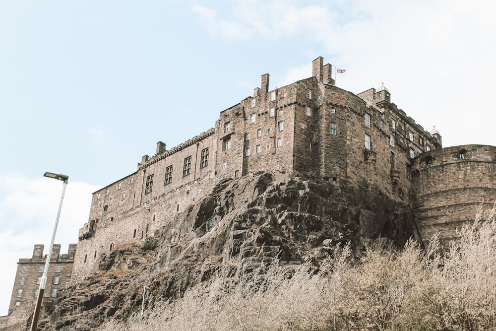 brown concrete building on top of mountain