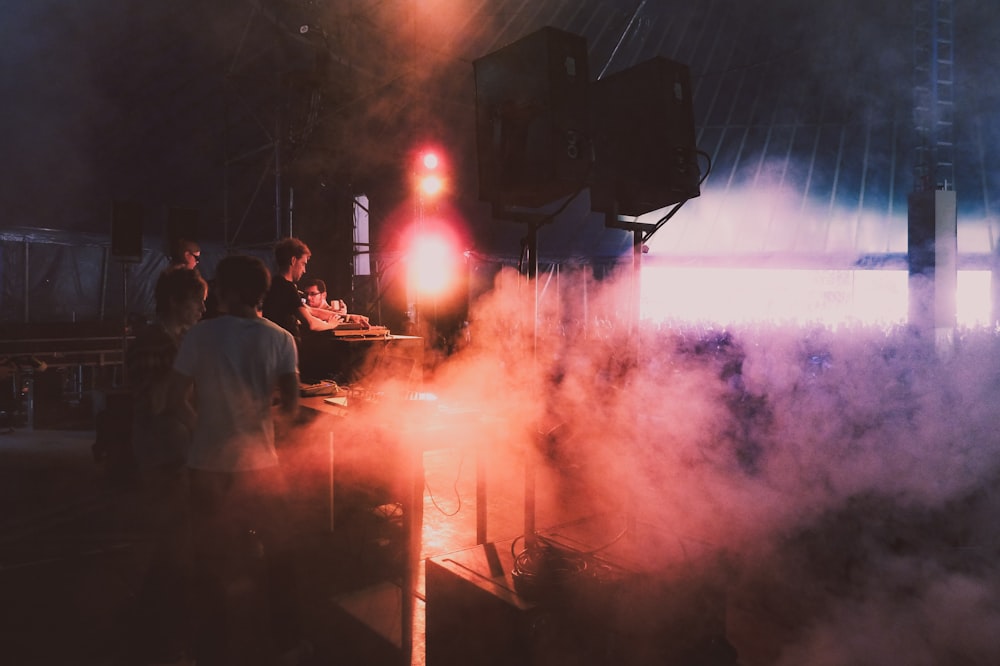 people standing near fire during night time