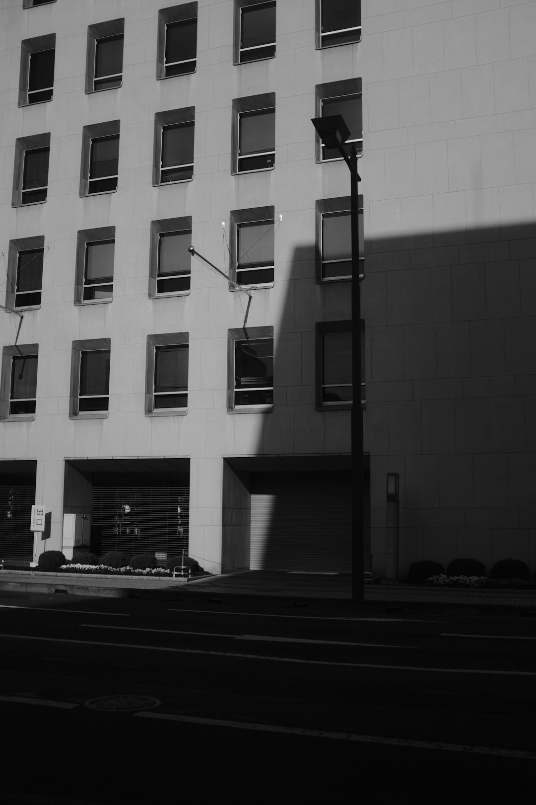 grayscale photo of building with glass windows