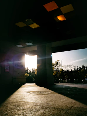Sunlight streaming through the open door as a customer steps into the colorful trezhas market.