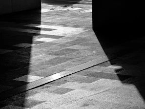 An artistic photograph capturing natural light and shadows in an urban setting.