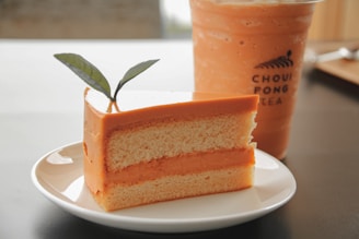 Slices of chiffon orange cake with delicate layers and a light dusting of powdered sugar