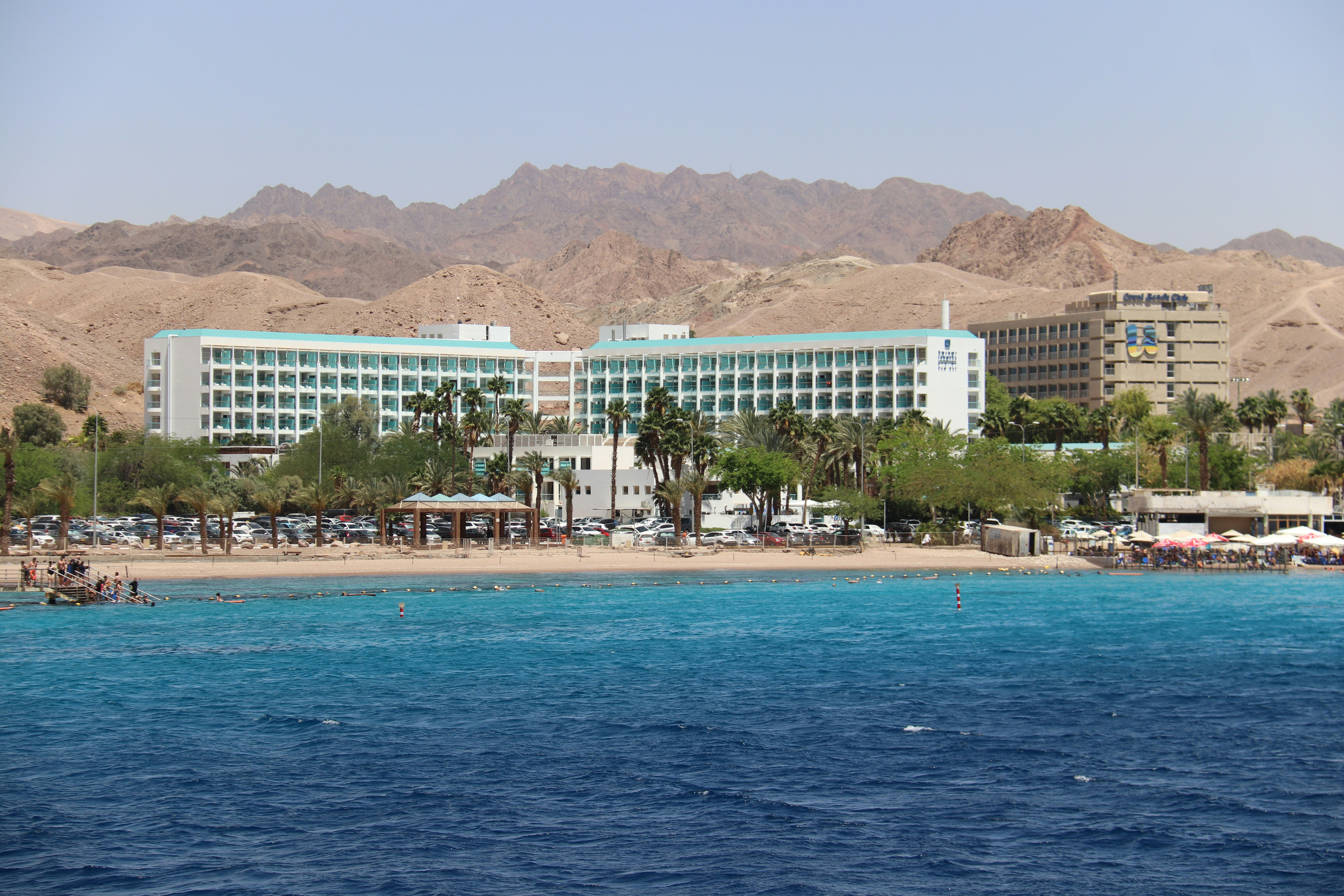 white concrete building near body of water during daytime