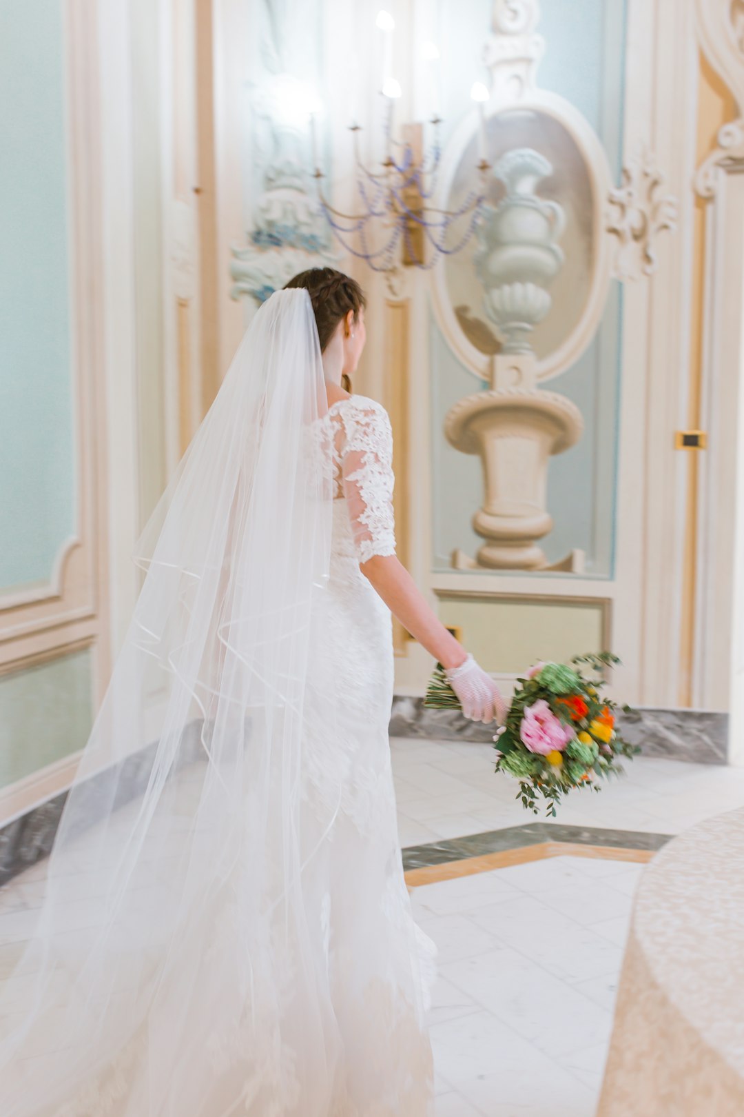 woman in white wedding dress holding bouquet of flowers