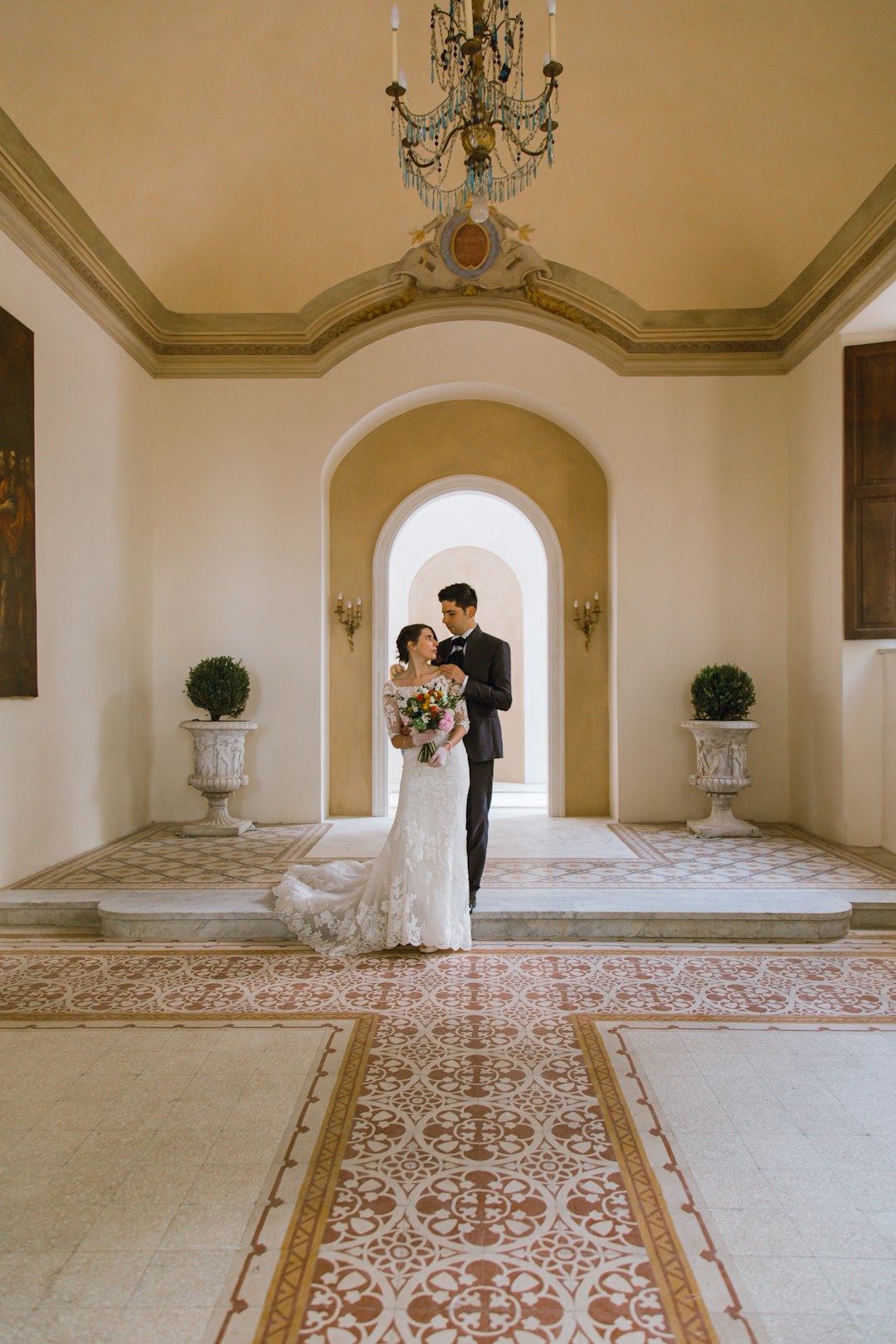 bride and groom standing on white and brown floral carpet