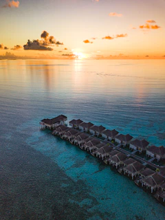 Crystal-clear turquoise waters and overwater bungalows in the Maldives at dawn