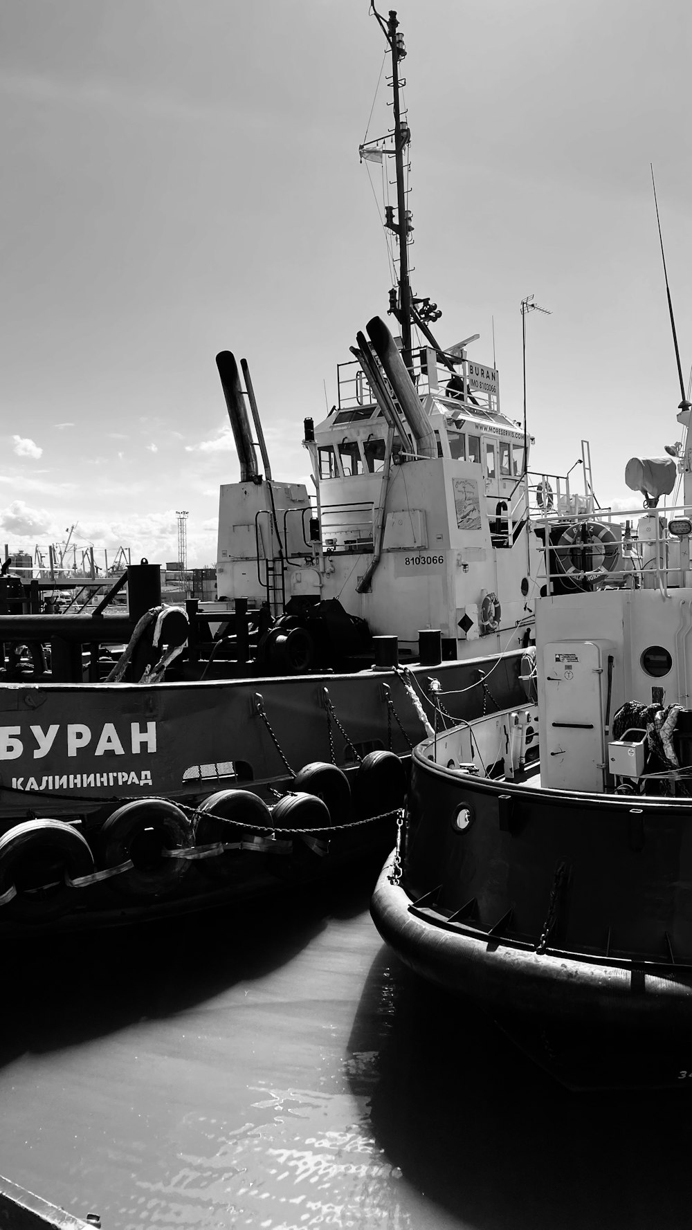 grayscale photo of boat on dock